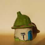 small ceramic house incense holder with hand-painted details and textured roof