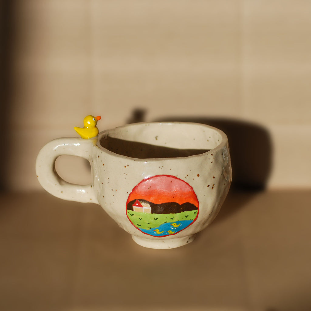 Handmade ceramic mug with whimsical face, made in the Netherlands