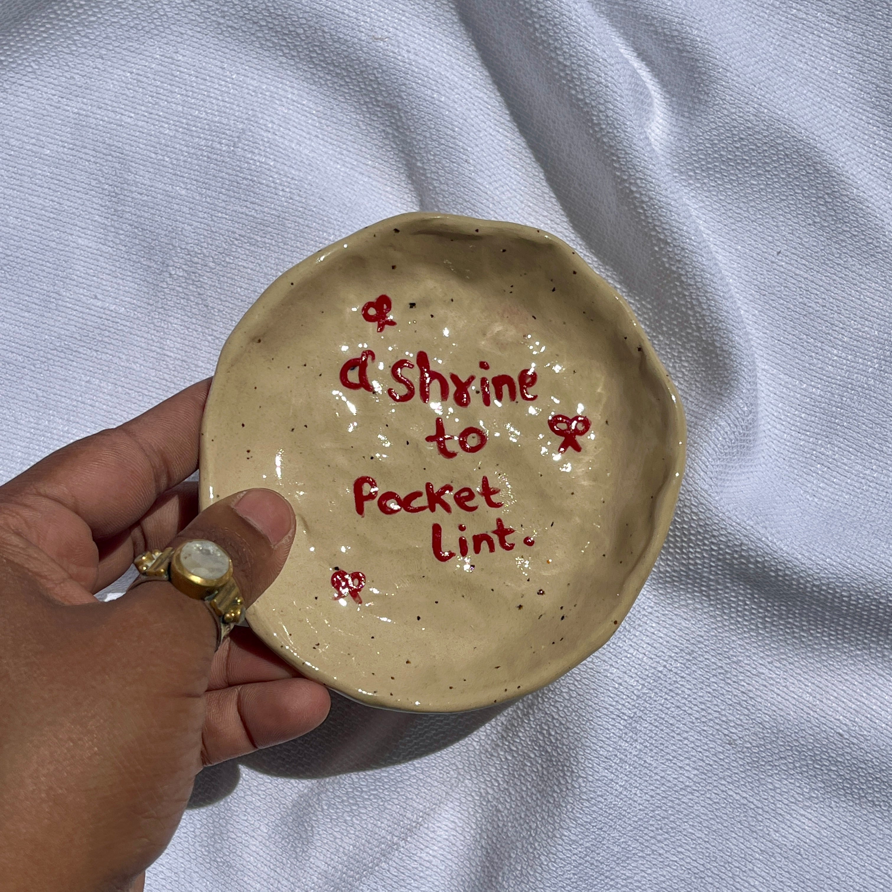 handmade ceramic trinket dish labelled shrine to pocket lint, whimsical stoneware Netherlands 