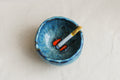 Blue ceramic ashtray with koi fish inspired by a midnight scene kept on a beige background