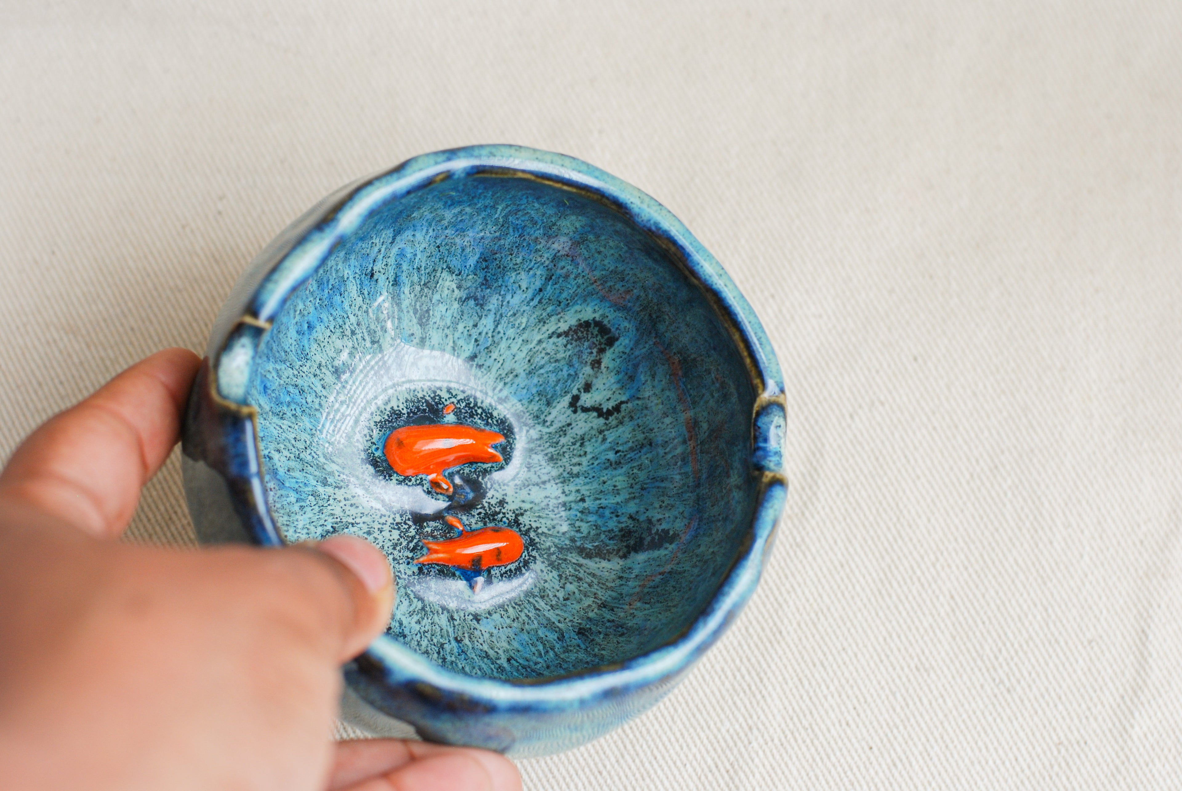 Blue ceramic ashtray with small ceramic koi fish inside made by pipa pots in the netherlands