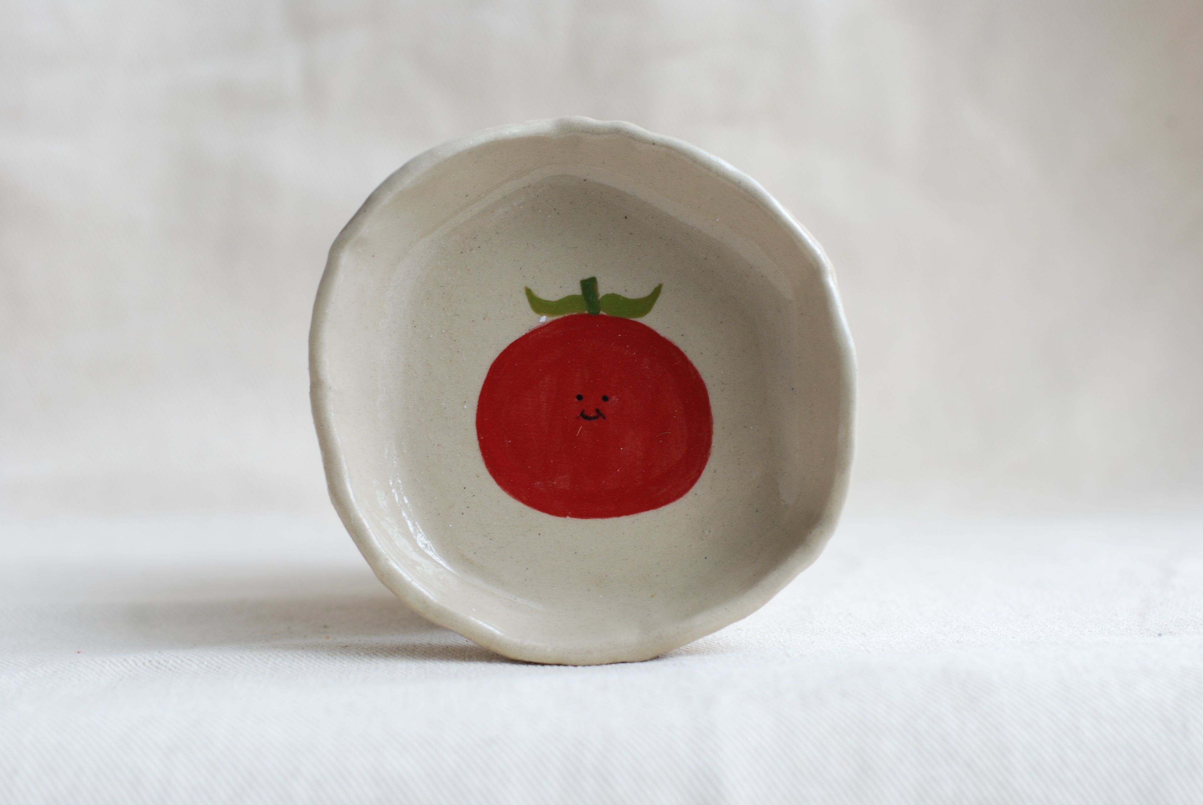 handmade ceramic trinket dish with smiling tomato