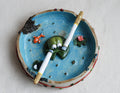 Ceramic ashtray with smoking frog design on a white background made by pipa pots 