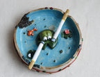 Ceramic ashtray with smoking frog design on a white background made by pipa pots 