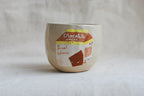 handmade ceramic cup with hand-painted chocolate milk carton illustration, whimsical stoneware