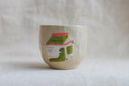 handmade ceramic cup with hand-painted matcha carton illustration, whimsical stoneware