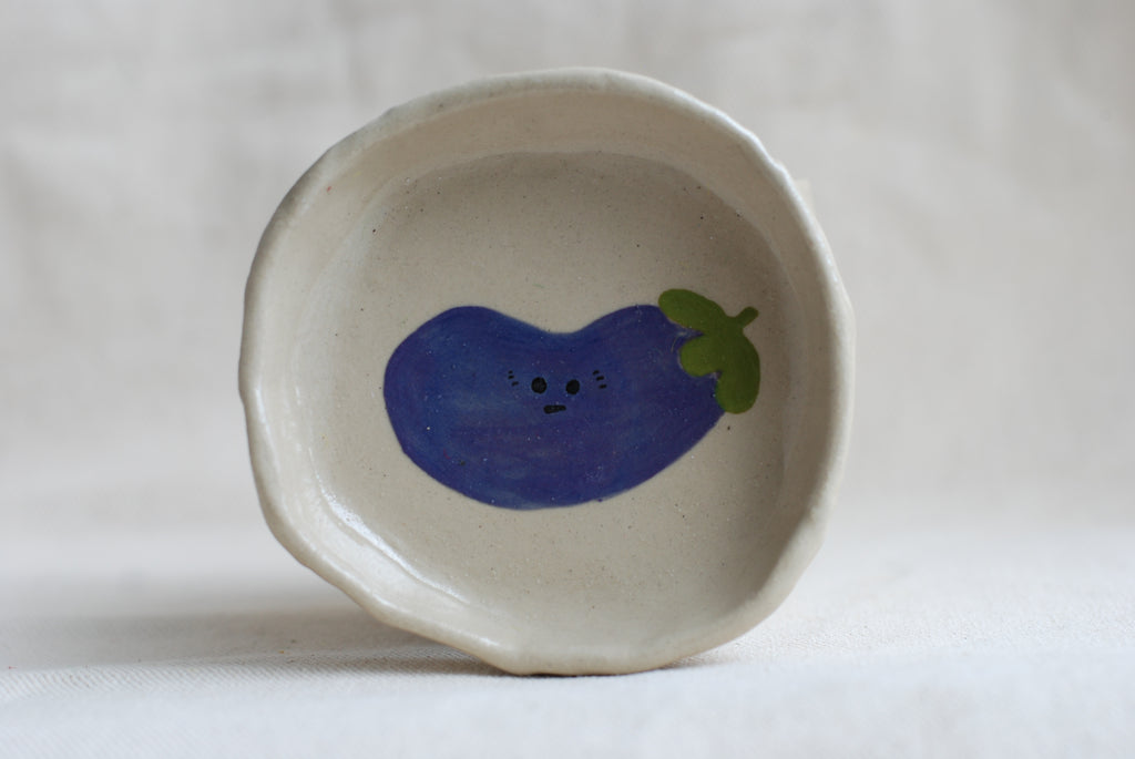 handmade ceramic trinket dish with hand-painted awkward aubergine, whimsical stoneware Netherlands