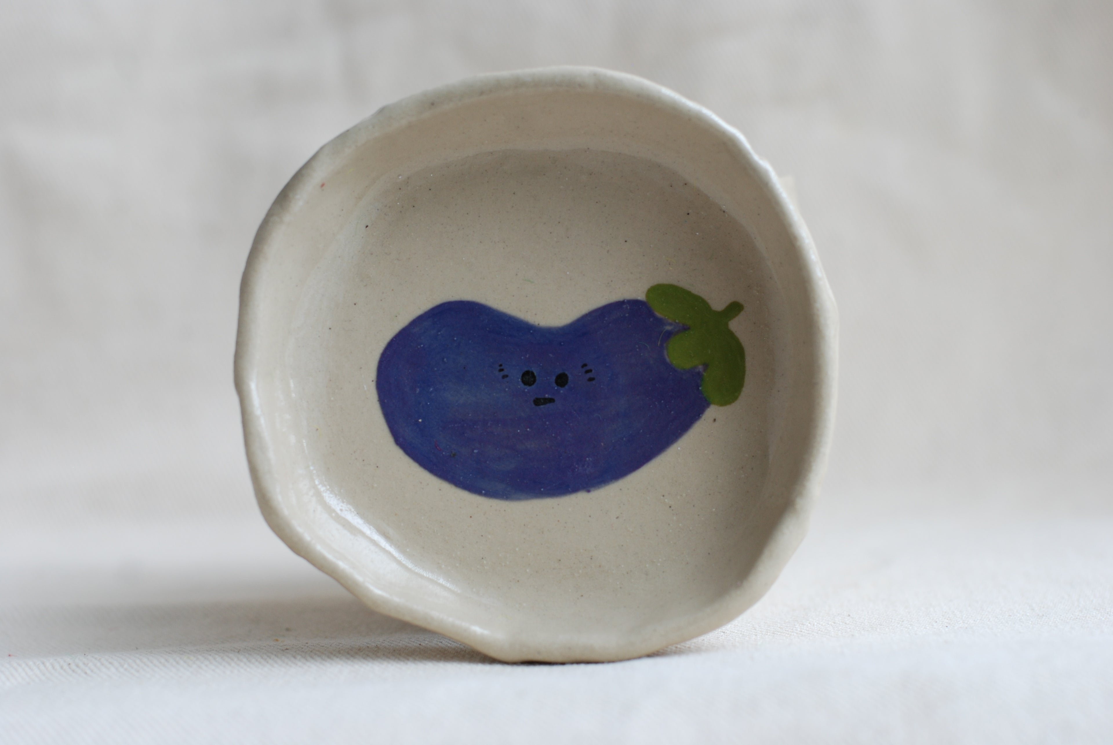 handmade ceramic trinket dish with hand-painted awkward aubergine, whimsical stoneware Netherlands
