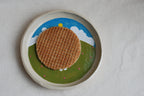 handmade ceramic plate with hand-painted bunny in flower meadow, whimsical stoneware netherlands