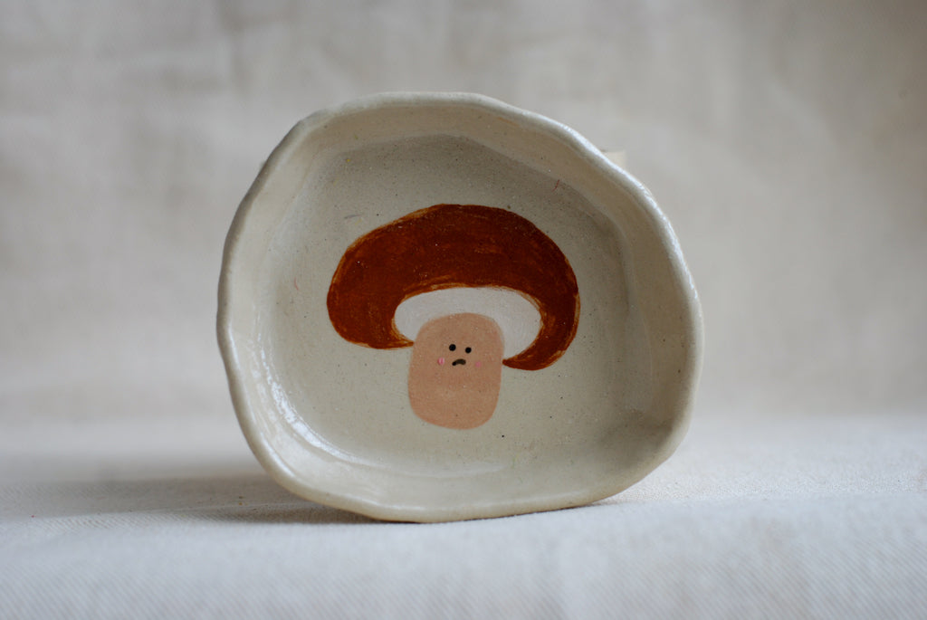 handmade ceramic trinket dish with hand-painted sad mushroom, whimsical stoneware