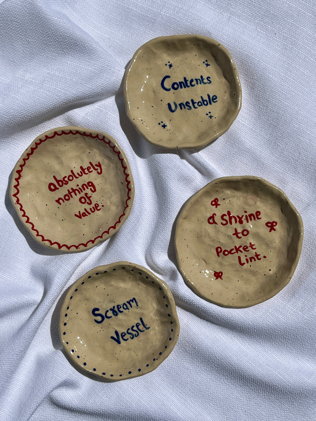 a shrine to pocket lint ceramic dish top view, cute whimsical pottery pipa pots
