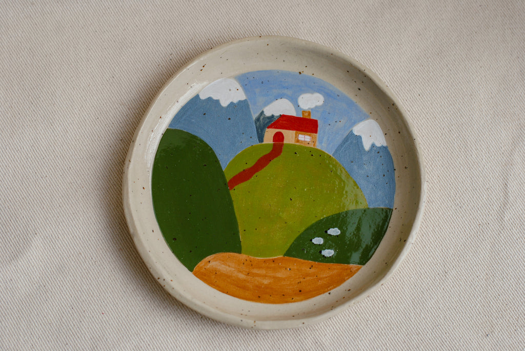 hand-painted stoneware plate featuring rolling hills and a path. handpainted by pipa pots