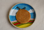 whimsical ceramic plate with colourful windmill scene